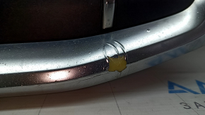 The Audi Q7 2020-2024 gray radiator grille assembly, with bracket and camera mount, is cracked and the chrome is peeling off.