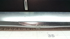 The Audi Q7 2020-2024 gray radiator grille assembly, with bracket and camera mount, is cracked and the chrome is peeling off.
