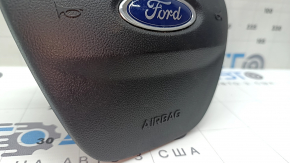 The steering wheel airbag on the driver's side of a Ford Escape MK4 20-26 has scratches.