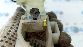 The front left door handle mechanism of a Kia K5 21-26 has a broken mount.