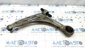 The lower front right control arm of a Kia K5 21-26 has a torn silent block.
