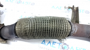 The exhaust pipe with catalytic converters on a VW Tiguan 09-18 has a torn mesh.