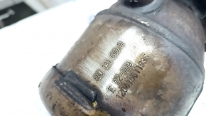 The exhaust pipe with catalytic converters on a VW Tiguan 09-18 has a torn mesh.
