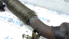 The exhaust pipe with catalytic converters on a VW Tiguan 09-18 has a torn mesh.