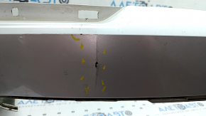 The bare lower rear bumper of a Volvo XC90 16-26 for parking sensors, without one parking sensor mount, white, scratches