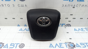 The driver's steering wheel airbag for a Toyota Prius 50 16-22 is black, scratched, and has a rusty squib.