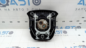 The driver's steering wheel airbag for a Toyota Prius 50 16-22 is black, scratched, and has a rusty squib.