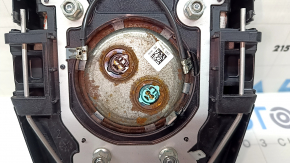 The driver's steering wheel airbag for a Toyota Prius 50 16-22 is black, scratched, and has a rusty squib.