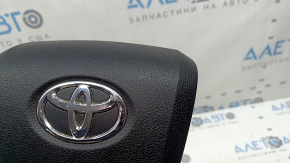 The driver's steering wheel airbag for a Toyota Prius 50 16-22 is black, scratched, and has a rusty squib.