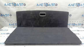 The trunk floor of a Hyundai Tucson 16-21 is black, worn, and the fabric is peeling off.