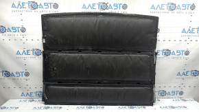 The trunk floor of a Hyundai Tucson 16-21 is black, worn, and the fabric is peeling off.
