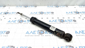 The rear left shock absorber of the Nissan Rogue 21-23 is dented.