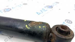 The rear right shock absorber of the Nissan Rogue 21-23 is dented.