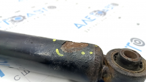 The rear left shock absorber of the Nissan Rogue 21-23 is dented.