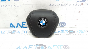 The BMW X7 G07 19-26 steering wheel airbag, black, scratched, and rusty squib