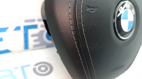 The BMW X7 G07 19-26 steering wheel airbag, black, scratched, and rusty squib