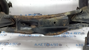 The rear subframe of a Toyota Prius 50 19-22 AWD is rusty, the inserts are torn off.