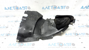 The front right fender liner, lower part, BMW X7 G07 19-26, is dented and has tears.