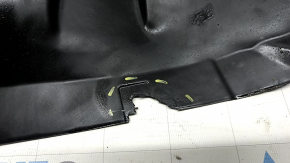 The front right fender liner, lower part, BMW X7 G07 19-26, is dented and has tears.