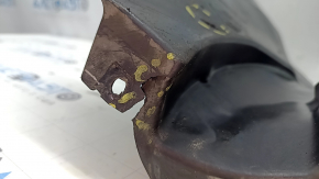The front left fender liner, lower part, BMW X7 G07 19-26, is dented and has tears.