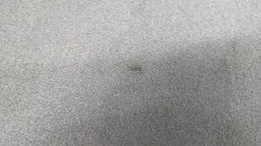The trunk floor of a Hyundai Santa FE Sport 13-18 is black and has dents.