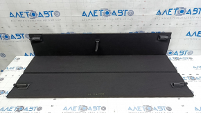 The trunk floor of a Hyundai Santa FE Sport 13-18 is black and has dents.