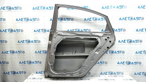 The bare rear right door of a Hyundai Sonata 11-15 hybrid, silver, FHM, after repair.
