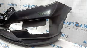 The front bumper of the Nissan Rogue 17-20 is dented.
