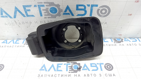 The fuel filler door housing of a Hyundai Sonata 11-15 has broken fasteners and a torn seal.