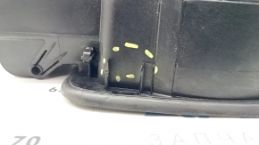 The fuel filler door housing of a Hyundai Sonata 11-15 has broken fasteners and a torn seal.