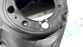 The fuel filler door housing of a Hyundai Sonata 11-15 has broken fasteners and a torn seal.