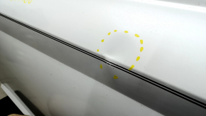 The front left door of a Hyundai Sonata 20-23, white, WC9, has dents.