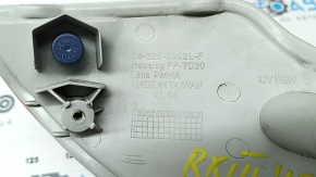 The left rear bumper light of a Lexus RX350 RX450h 10-15 has a broken lampshade.