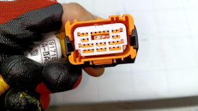 The Hyundai Sonata 20 SRS airbag computer module chip is orange.