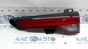 The right Mitsubishi Outlander 22-26 trunk door inner light has a cracked mount and scratches.