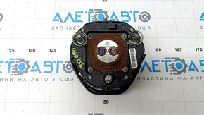 The steering wheel airbag for the driver's side of the Hyundai Santa FE 19-23 is black and has a rusty squib.