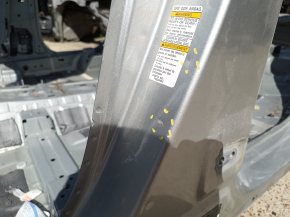 The central left body pillar of a Mitsubishi Outlander 22-26 is on the body, dented, and has bumps.