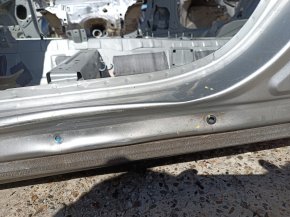 The central left body pillar of a Mitsubishi Outlander 22-26 is on the body, dented, and has bumps.