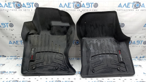 A set of floor mats for the Land Rover Range Rover Velar, black rubber, Weathertech 18-26, with a dented driver's mat.