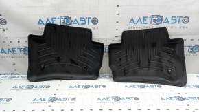 A set of floor mats for the Land Rover Range Rover Velar, black rubber, Weathertech 18-26, with a dented driver's mat.