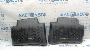 A set of floor mats for the Land Rover Range Rover Velar, black rubber, Weathertech 18-26, with a dented driver's mat.