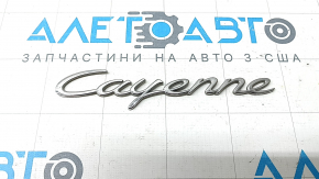 The Cayenne emblem on the tailgate of the Porsche Cayenne 19-23 is chrome.