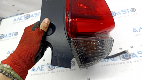 Nissan Rogue 17-20 right outer fender light has scratches and a missing piece of glass.