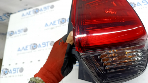 Nissan Rogue 17-20 right outer fender light has scratches and a missing piece of glass.