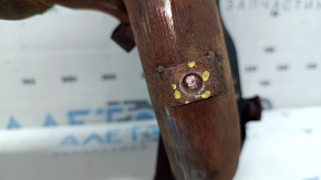 The exhaust manifold with a catalytic converter for a Nissan Rogue 14-17 type 1 is rusty and has broken bolts.