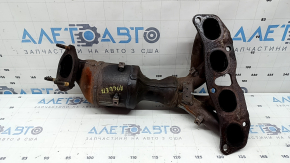 The exhaust manifold with a catalytic converter for a Nissan Rogue 14-17 type 1 is rusty and has broken bolts.