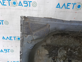 The trunk trough of a Honda Accord 23-26 is drilled out and dented.