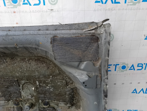 The trunk trough of a Honda Accord 23-26 is drilled out and dented.