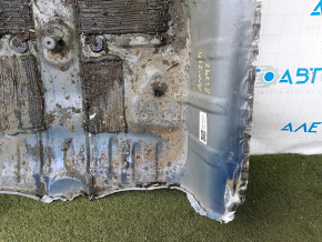 The trunk trough of a Honda Accord 23-26 is drilled out and dented.