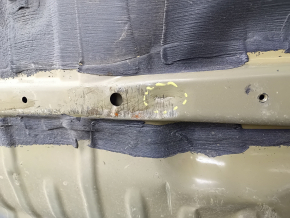 The trunk trough of a Honda Accord 23-26 is drilled out and dented.